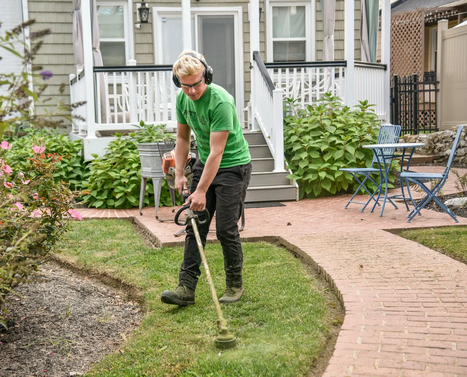String-trimmer cutting a clean edge along a residential sidewalk in Westlake.